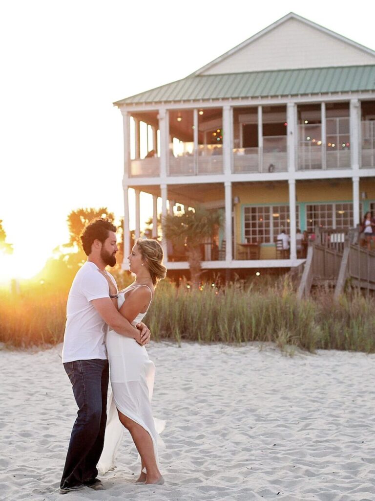 man and woman hugging each other on a winter beach vacation